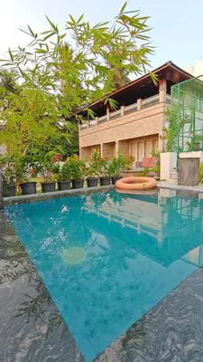 a pool with blue water in front of a building at Cherai Beach Regency in Ernakulam