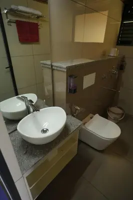 a bathroom with a sink and a toilet at Misty Slope in Panamaram