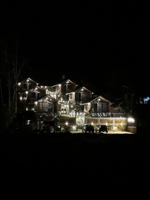a large house lit up at night with lights at Misty Slope in Panamaram