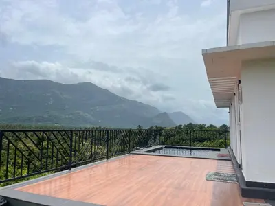 a balcony with a view of the mountains at Bougainvillea HillView Retreat in Palakkad