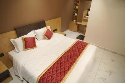 a bedroom with a large bed with two pillows at Bougainvillea HillView Retreat in Palakkad