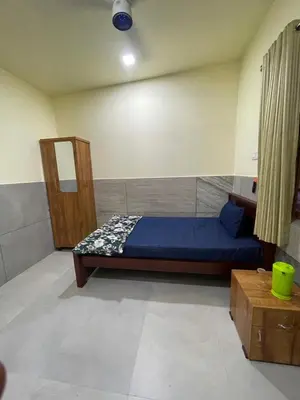 a bedroom with a blue bed in a room at Mp DREAMS ROOMS in Edappāl