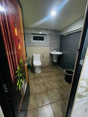 a bathroom with a toilet and a sink at Mp DREAMS ROOMS in Edappāl