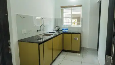 a kitchen with a sink and a counter top at Panakkal Homes in Guruvāyūr