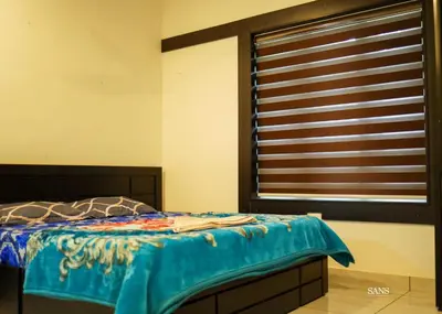 a bedroom with a bed and a window at Paddy Land in Wayanad