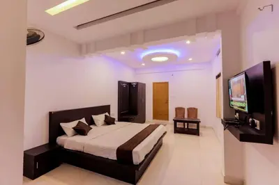 a bedroom with a bed and a flat screen tv at Igloo Residency in Vythiri