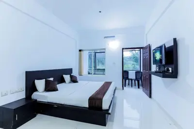 a bedroom with a bed and a television in it at Igloo Residency in Vythiri