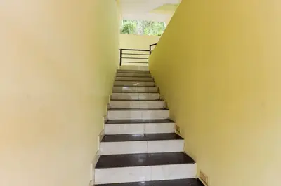 a staircase leading up to a room with yellow walls at Igloo Residency in Vythiri