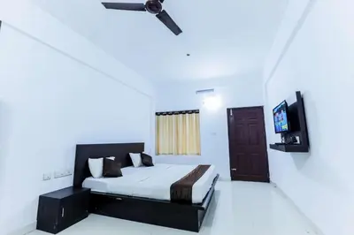 a bedroom with a bed and a flat screen tv at Igloo Residency in Vythiri