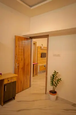 a hallway with a door and a plant in a room at Cozy Nest Villa in Mananthavady
