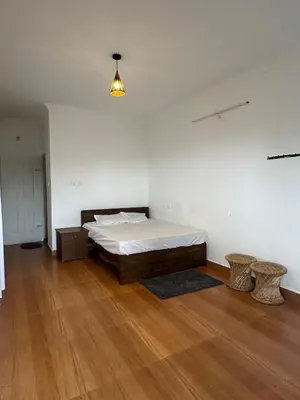a bedroom with a bed and a wooden floor at Elim Retreat kanthalloor in Kanthalloor