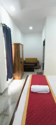 a room with a red rug on the floor at Blue home stay in Kanthalloor