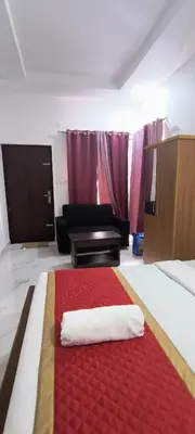 a hotel room with a bed with a red rug at Blue home stay in Kanthalloor