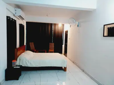 a bedroom with a bed and a table and chairs at Anam residence in Tāzhekkod