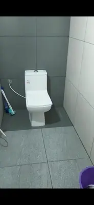 a bathroom with a white toilet in a stall at Anam residence in Tāzhekkod