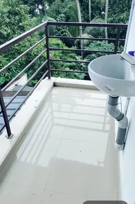 a bathroom with a sink on a balcony at Aswathy Bhavan Vadakkenchery Near Star auditorium in Vadakkāncheri