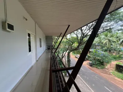 a staircase in a house with a view of the street at Mundodan complex in Nilambūr