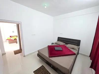 a bedroom with a bed with a red folder on it at SRB Cottages in Ooty