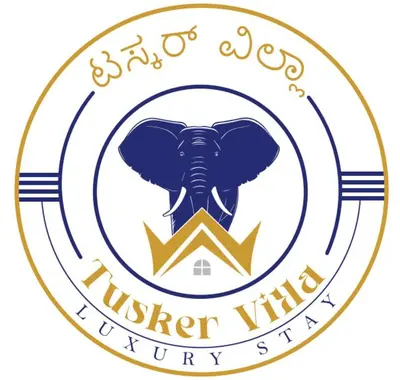 an elephant in a gold circle with the words under virgin authority at Tusker villa in Suntikoppa