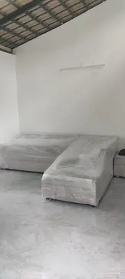 a large bed sitting in a white room at Tusker villa in Suntikoppa