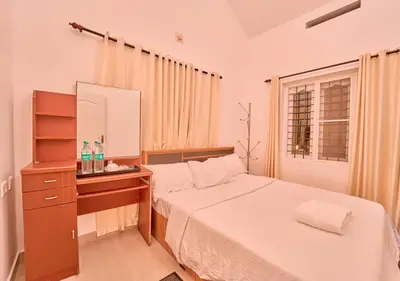 a bedroom with a bed and a dresser and a mirror at Kedara Resort Wayanad by VOYE HOMES - Pet Friendly with Pool in Sultan Bathery