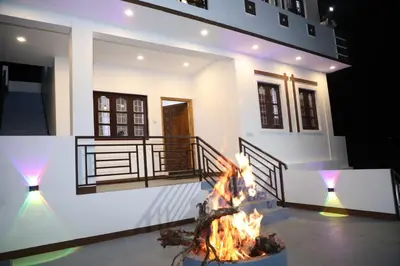 a house with a fire in front of it at Climate Dull - Homestay Villa in Ketti