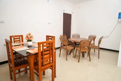 a dining room with a table and chairs at Climate Dull - Homestay Villa in Ketti