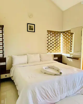 a white bed with a towel on top of it at Zero Degree in Ketti