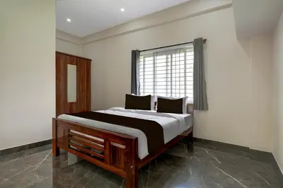 a bed in a room with a window at Hotel O Ambari Residency in Mysore