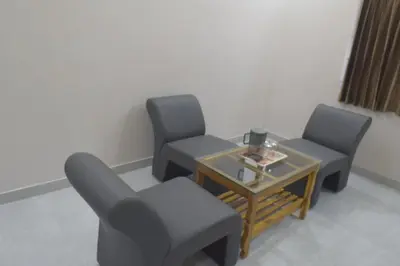 a waiting room with two chairs and a table at Maruthamalai Andavar Residency in Coimbatore