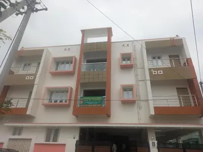 an apartment building with balconies on the side of it at Maruthamalai Andavar Residency in Coimbatore
