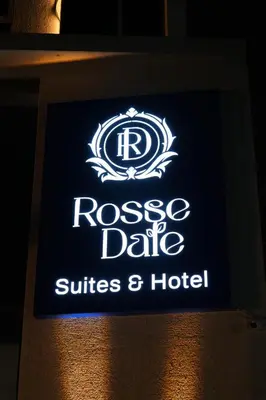 a sign for theres a sign for a hotel at Rosse Dale Suites and Hotel Coimbatore in Coimbatore