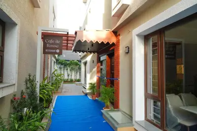a hallway of a building with a blue carpet at Rosse Dale Suites and Hotel Coimbatore in Coimbatore