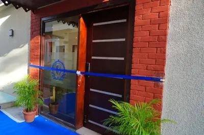 a door to a building with plants in front of it at Rosse Dale Suites and Hotel Coimbatore in Coimbatore