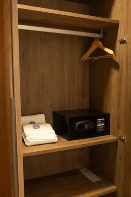 a microwave sitting on a shelf in a kitchen at Rosse Dale Suites and Hotel Coimbatore in Coimbatore