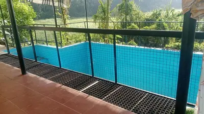 a view of a swimming pool from the balcony of a house at Suraj Stays Glowing Meadows in Chewarra