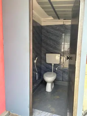 a bathroom with a toilet in a room at Fog view cottage - Homestay with food and internet in Vythiri