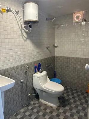 a bathroom with a toilet and a shower and a sink at Fog view cottage - Homestay with food and internet in Vythiri