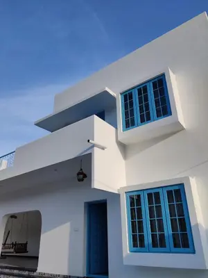 a white house with blue windows and a porch at 3BHK - Villa - a greece style - Kayal vizha - near isha yoga - coimbatore in Coimbatore