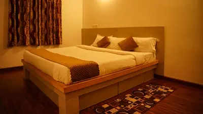 a bedroom with a large bed with white sheets and pillows at Willostays Cluster Clouds in Ooty