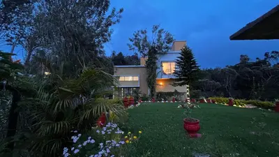 a house with a yard with flowers and plants at Willostays Cluster Clouds in Ooty
