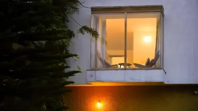 a window of a building with a reflection in it at Willostays Cluster Clouds in Ooty