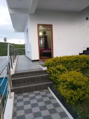 a stairway leading to a door of a house at diamond hill view cottage in Ooty
