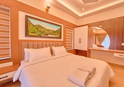 a bedroom with a large bed and a mirror at Villa Terra Verde Ooty by VOYE HOMES in Ooty
