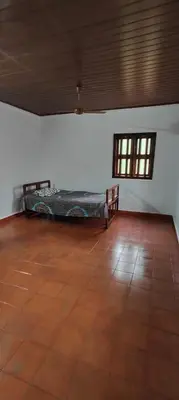 a room with a bed in the corner of a room at Traditional Kerala house, Kannur-Thalassery in Tellicherry