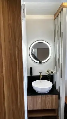a bathroom with a sink and a mirror at Paradise-Vadanappally Beach Villa for 4-5 adults in Irimbranallūr