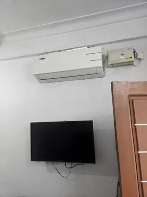 a television and a light hanging from a ceiling at grandresidency in Kāladi