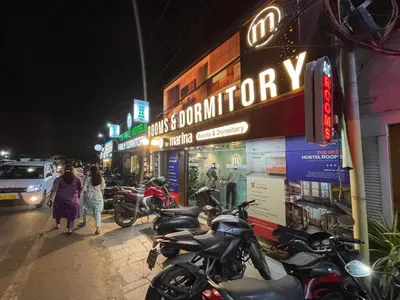 a group of motorcycles parked on a street at night at The Marina Kozhikode AC Rooms and Dorms Opposite to Beach in Kozhikode