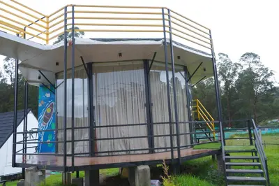 a small building with a playground with a slide at Airas Resort in Kūkkāl