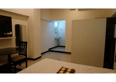 a room with a bed and a table and a room with a door at Room Stay non bookable in Udumalaippettai